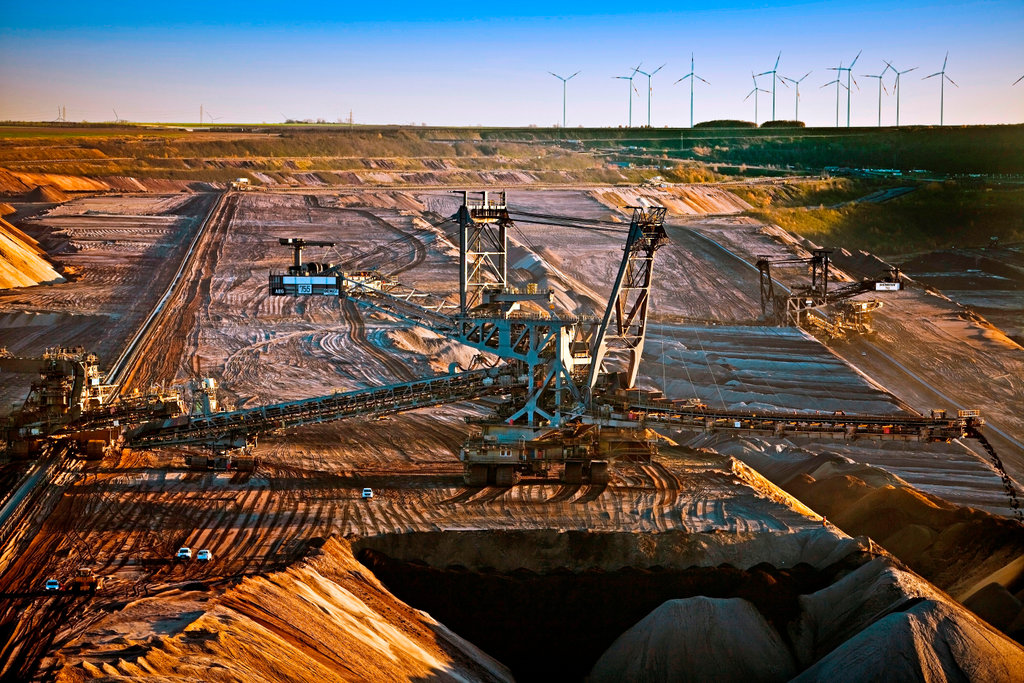Brown coal surface mining with stacker, wind turbines in background