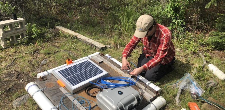 Scientist adjusting equipment IISD