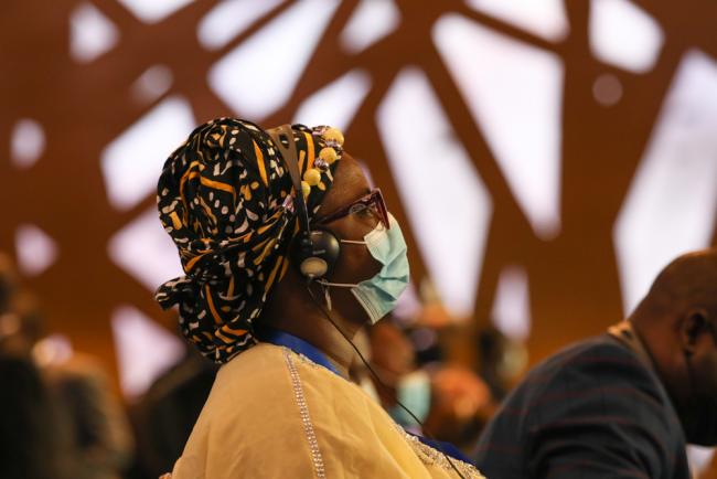 A delegate listens during the opening ceremony