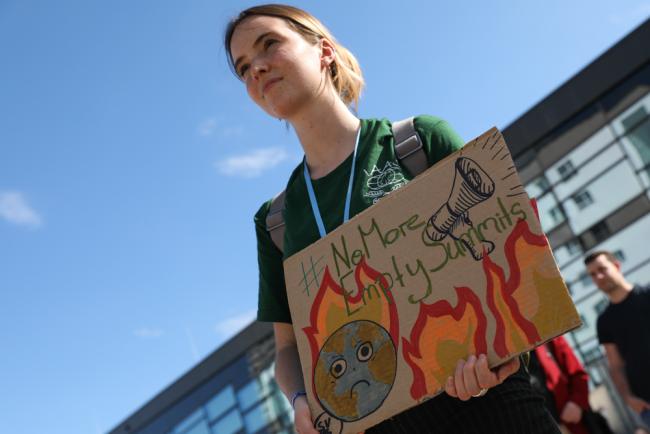As the negotiations continue for their fifth day, members of Fridays for Future protest outside calling for more action to be taken to address climate change