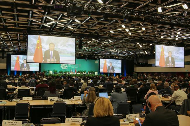 View of the room during a video message from Xi Jinping, President of the People’s Republic of China