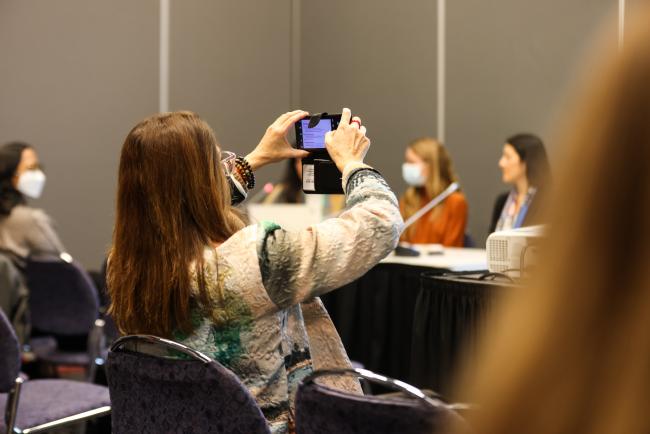 Participant takes a photo of the panel_SideEventsCBDCOP15_9Dec2022_Photo.jpg