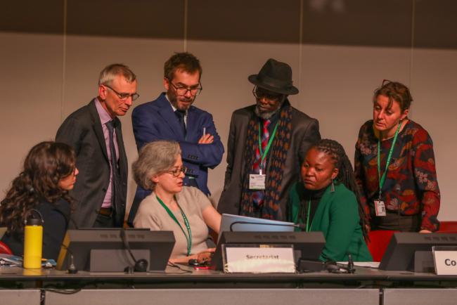The CBD Secretariat and Working Group Co-Chairs consult on the dais all attention turned to Digital Sequence Information (DSI)