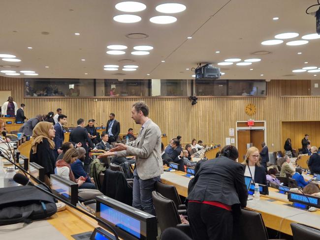 Delegates speaking informally before the start of the session